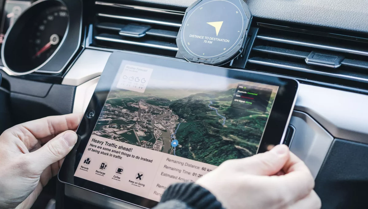 iPad showing navigation route and Prototype compass inside of car