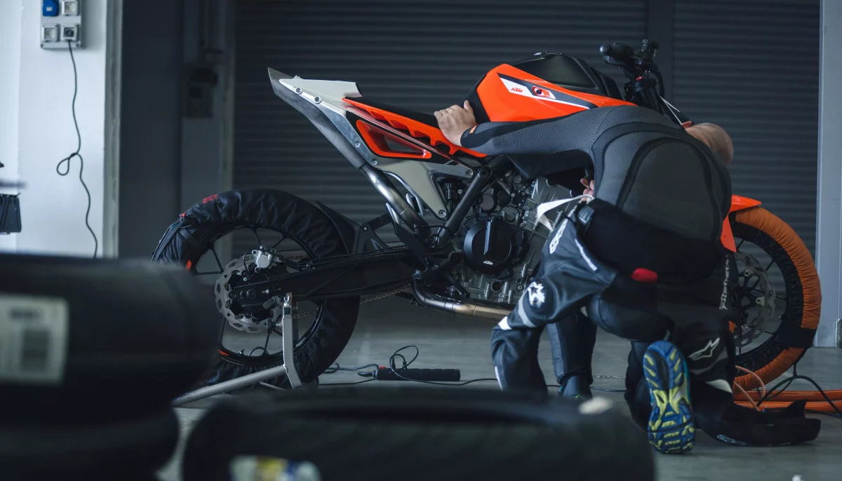 Side view of KTM 790 Duke prototype being tuned up by rider during video shoot and photo shoot