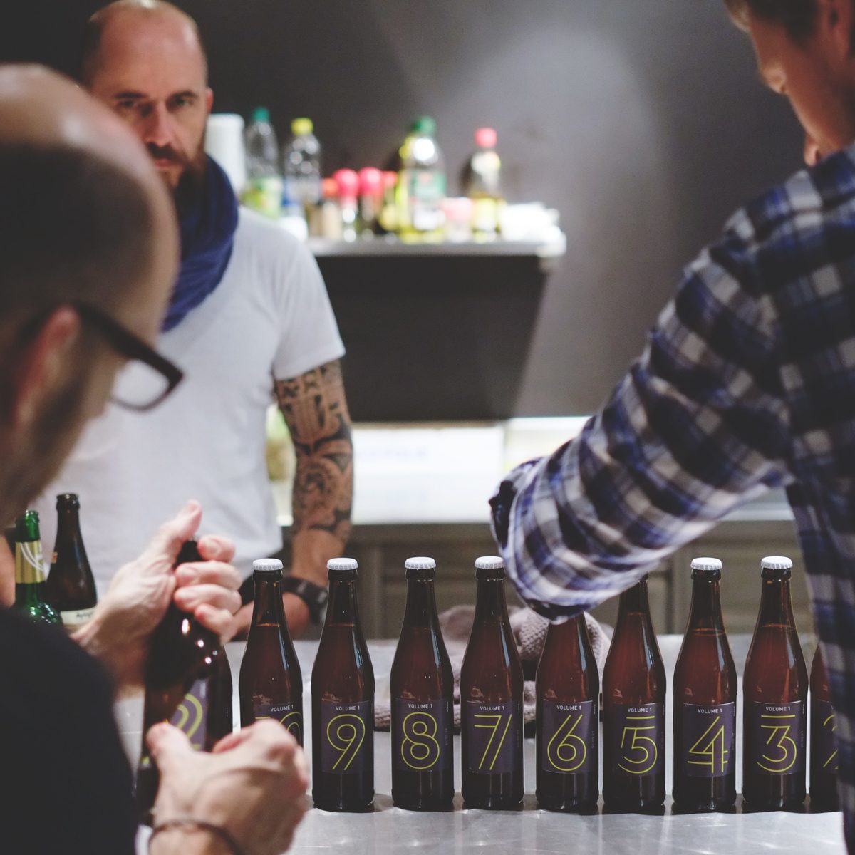 KISKA graphic designer, desktop publisher and product designer apply labels to KISKA-brewed beer