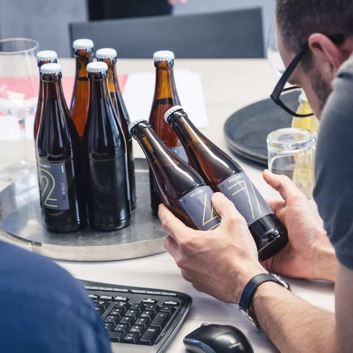 KISKA partner looks at graphic design of labels on beer brewed at KISKA