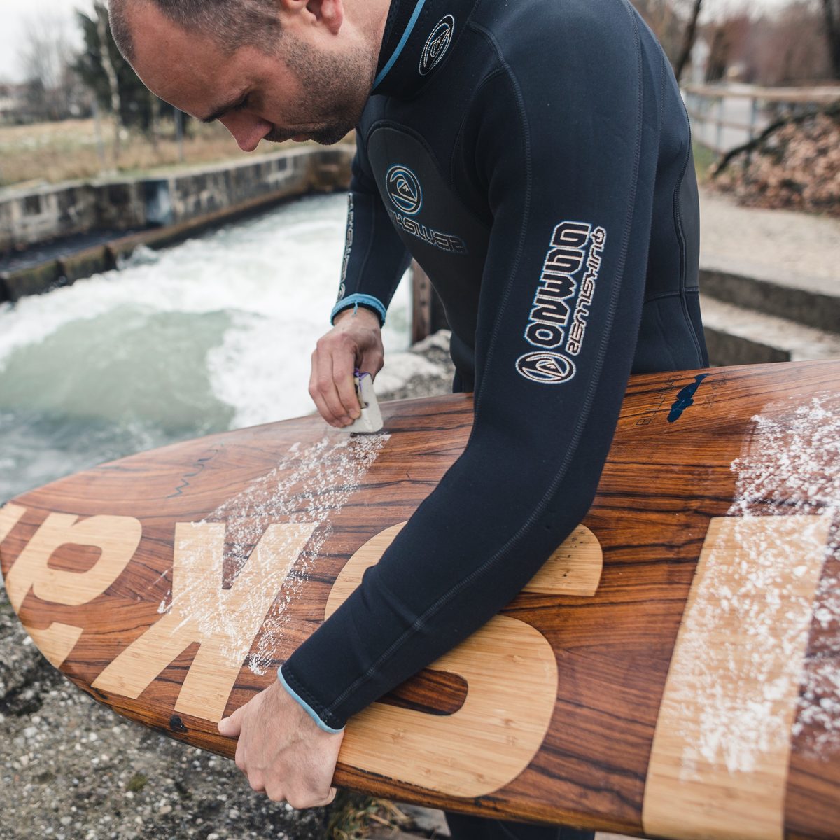 KISKA Managing Partner - Julian Herget waxes KISKA surfboard at the Salzburg river wave
