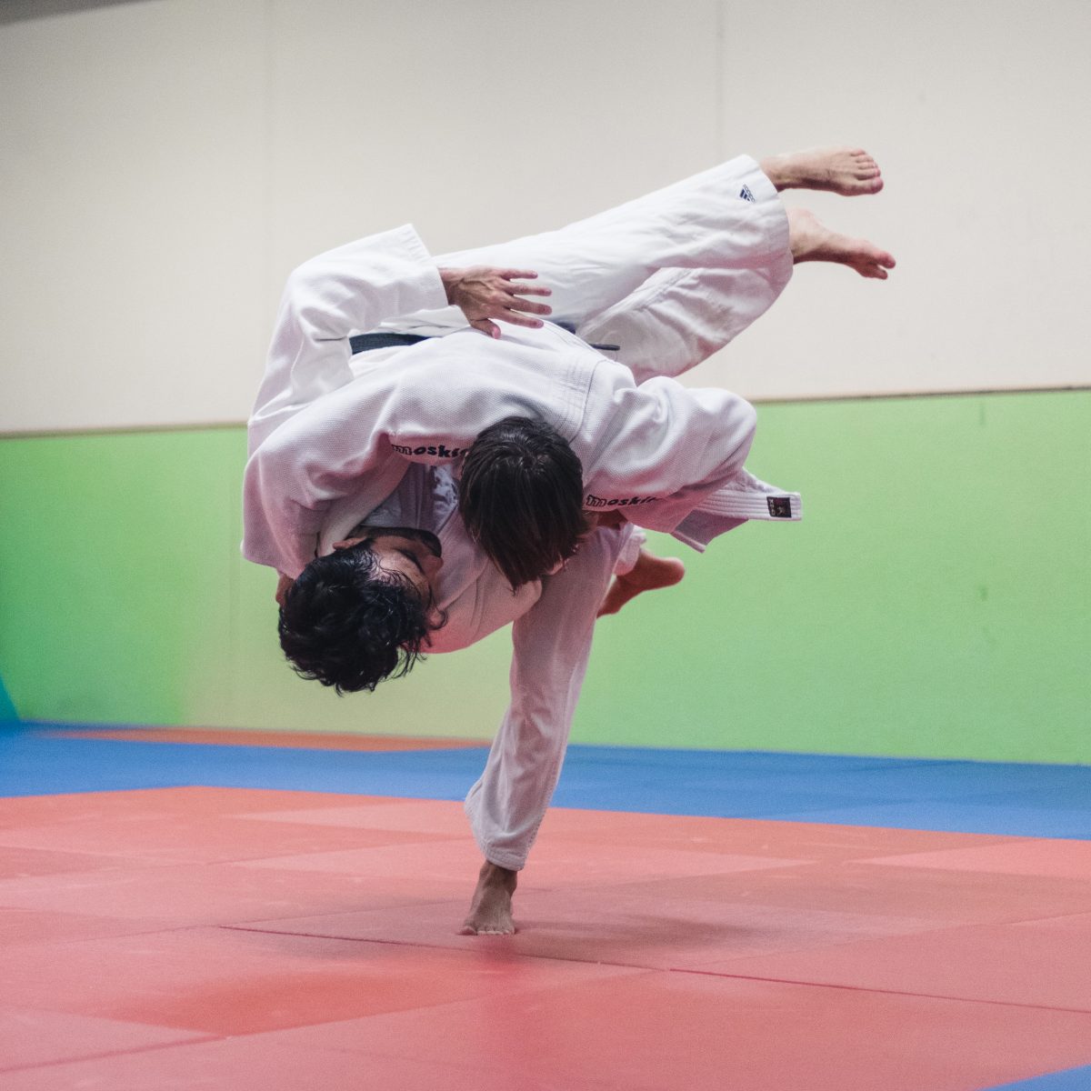 KISKA product management consultant and apparel designer grapple in judo dojo