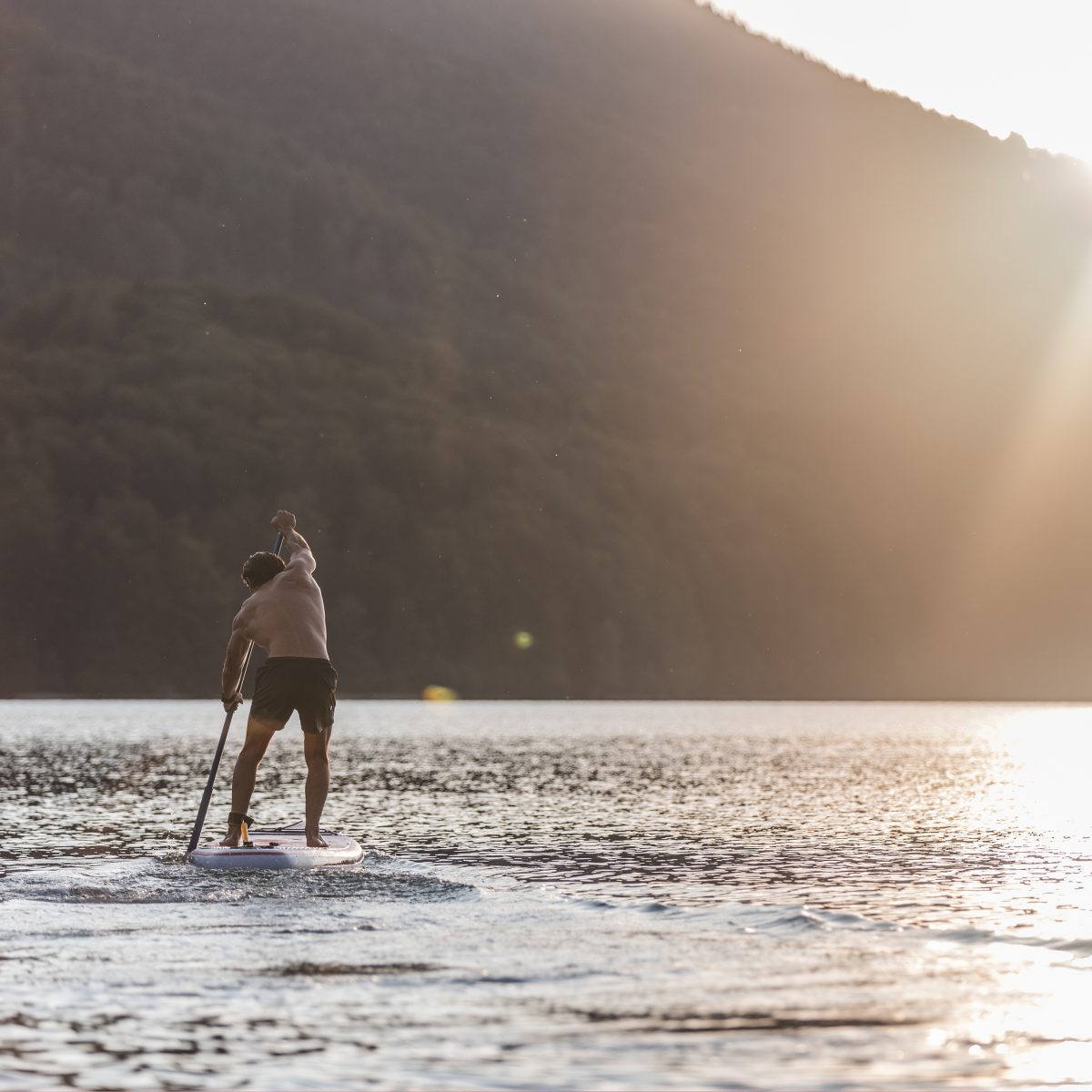 KISKA product management consultant paddle boarding on an Austrian alpine lake after work