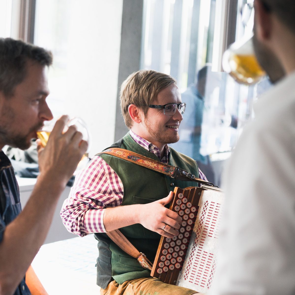 KISKA account manager playing the accordion at Oktoberfest after-work party