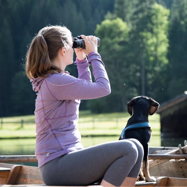 Woman with dog using Zeiss Sport Optics binoculars