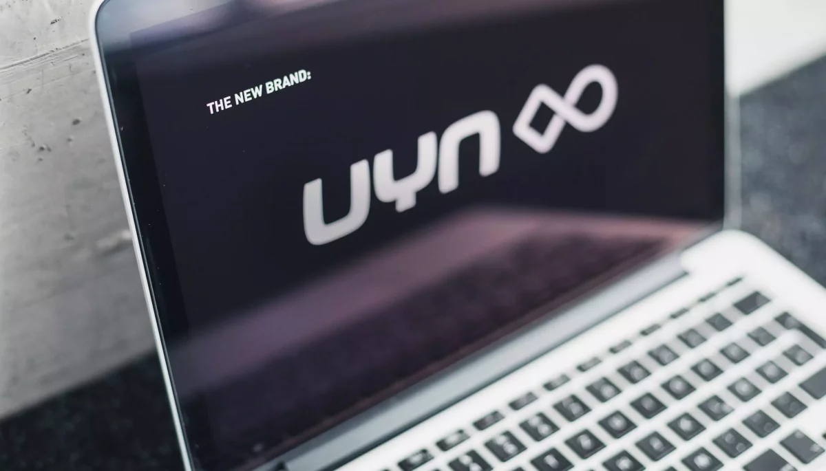 UYN communication design concept and website on a laptop